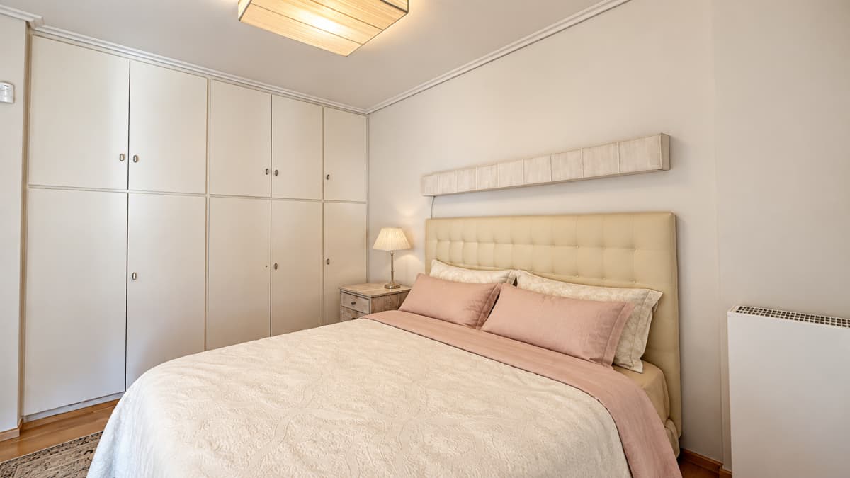 Bedroom with a double bed, built-in wardrobes, and a nightstand.