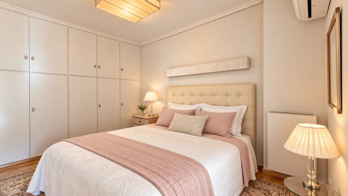 Bedroom with a double bed, built-in wardrobes, and a bedside table.