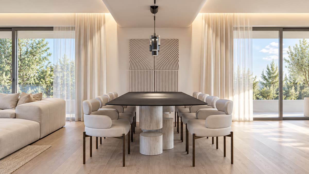 A modern dining area with a dark table and upholstered chairs in front of large windows with sheer curtains.