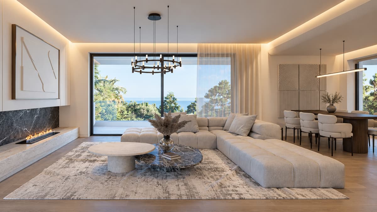 A modern living room featuring a large sectional sofa, a marble coffee table, a linear fireplace, and a dining area, with a large sliding glass door opening to a sea view.
