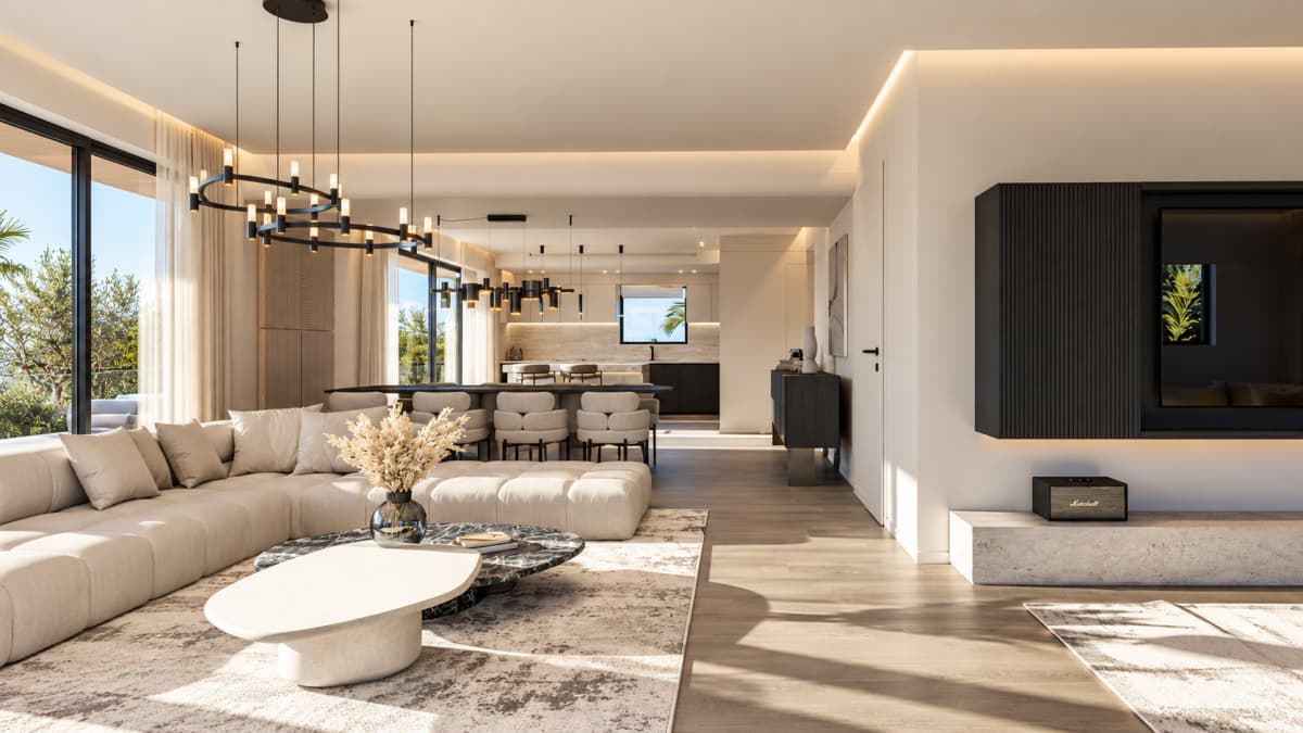 Open-plan living room with a beige sectional sofa, a marble coffee table, a kitchen island in the background, and a wall-mounted TV.
