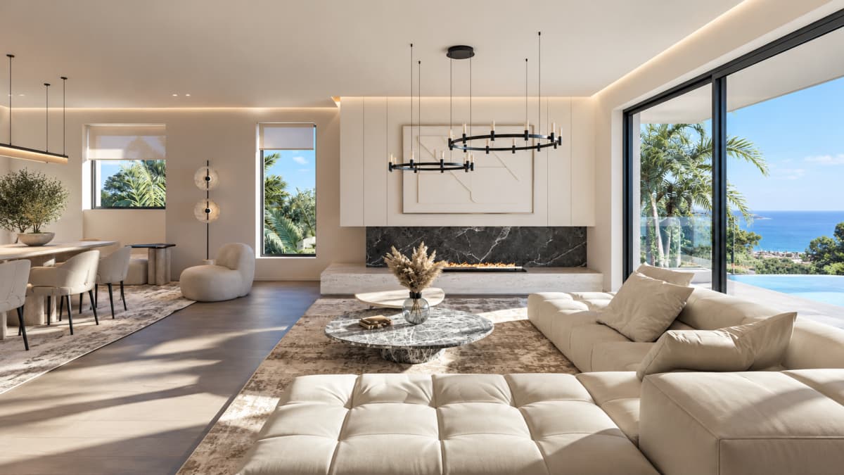 A modern living room featuring a large sectional sofa, a marble coffee table, a fireplace, and a sea view.