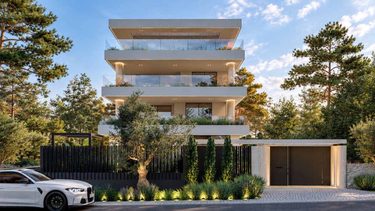Front exterior view of a modern multi-story residential building with balconies, a fence, gate, and a parked car.