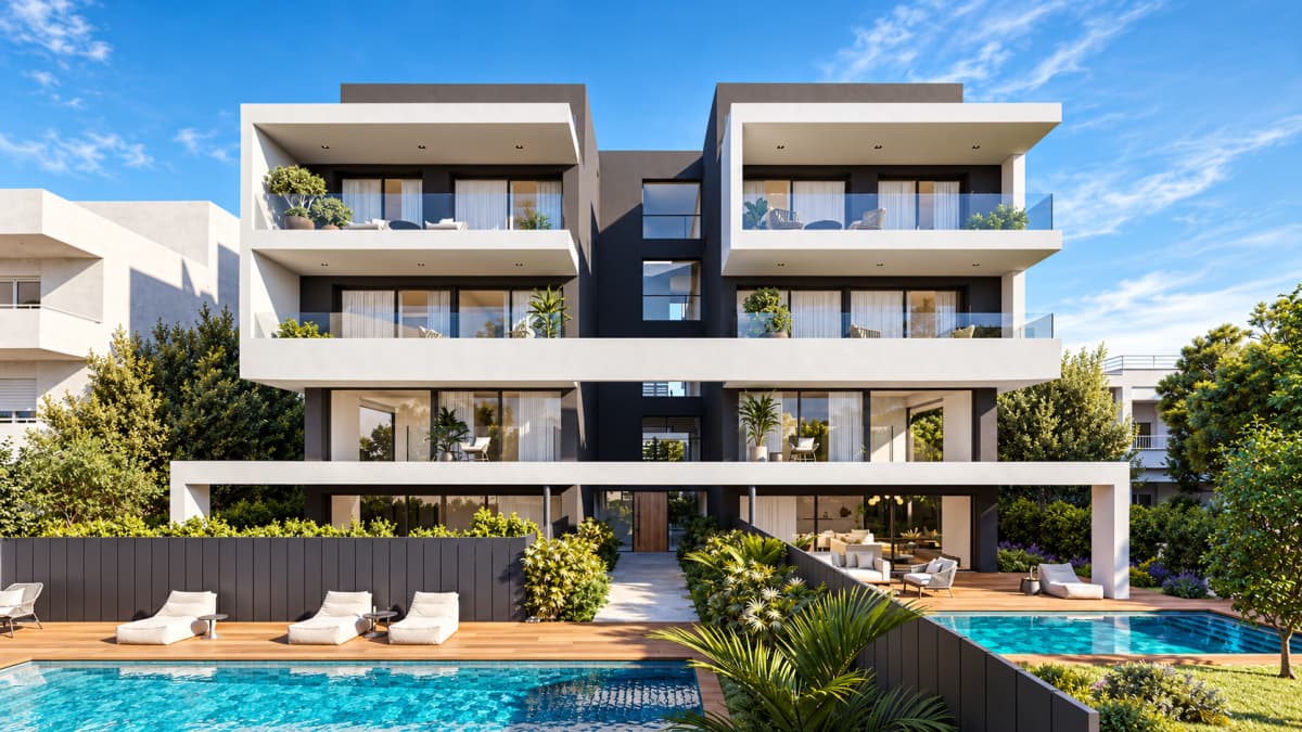 A modern multi-story apartment building with white balconies and dark gray walls features a swimming pool in the foreground surrounded by wooden decking and landscaping.