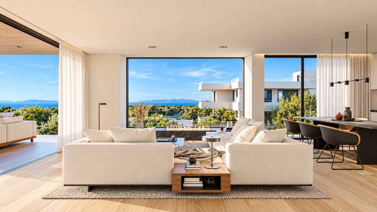 A modern living room featuring a large sectional sofa, a built-in linear fireplace, and expansive windows offering a sea view.