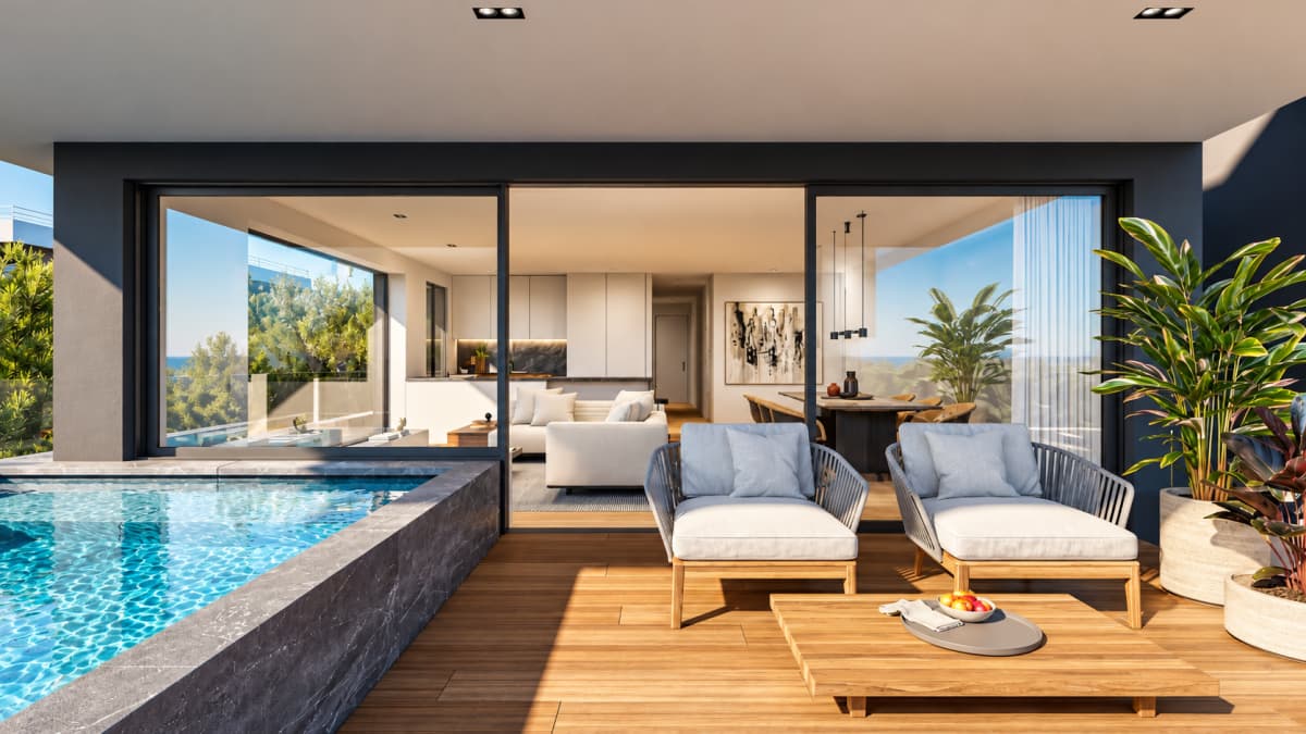 A modern terrace featuring a swimming pool, wooden decking, armchairs, and a coffee table, with open glass doors leading to an interior living area.